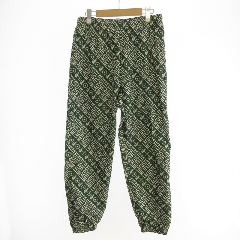【中古】LACOSTE | ラコステ 耐水総柄トラックパンツ パンツ XH9342 xNetflix グリーン サイズ:S