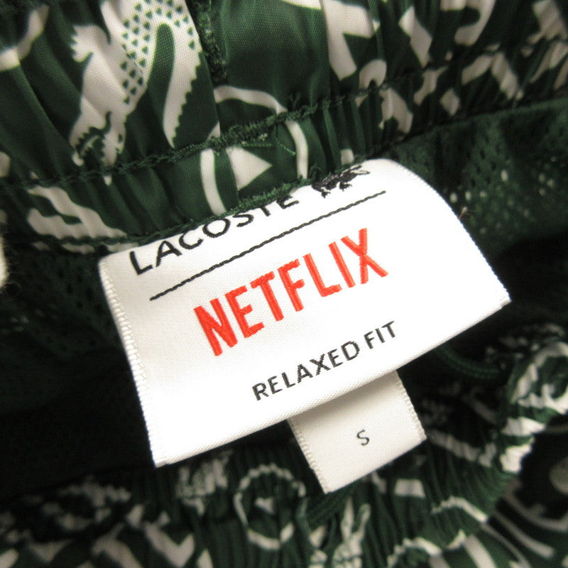 【中古】LACOSTE | ラコステ 耐水総柄トラックパンツ パンツ XH9342 xNetflix グリーン サイズ:S