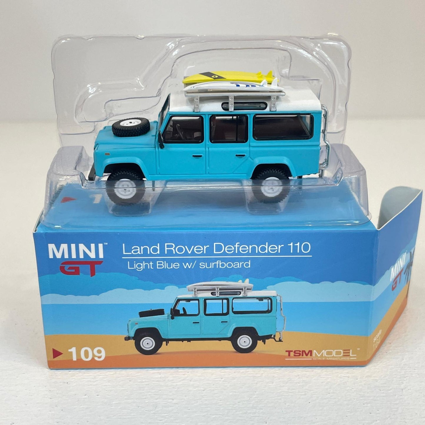 MINI GT 1/64 ランドローバー ディフェンダー 110 Light Blue w/surfboard【尾張小牧店】