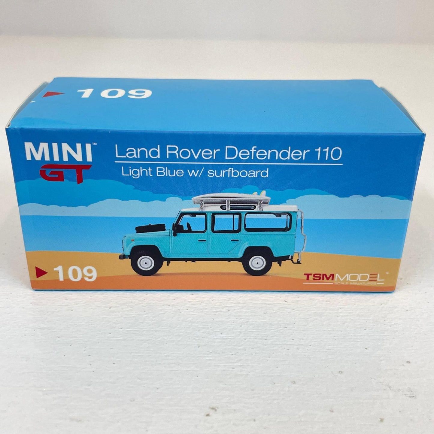 MINI GT 1/64 ランドローバー ディフェンダー 110 Light Blue w/surfboard【尾張小牧店】