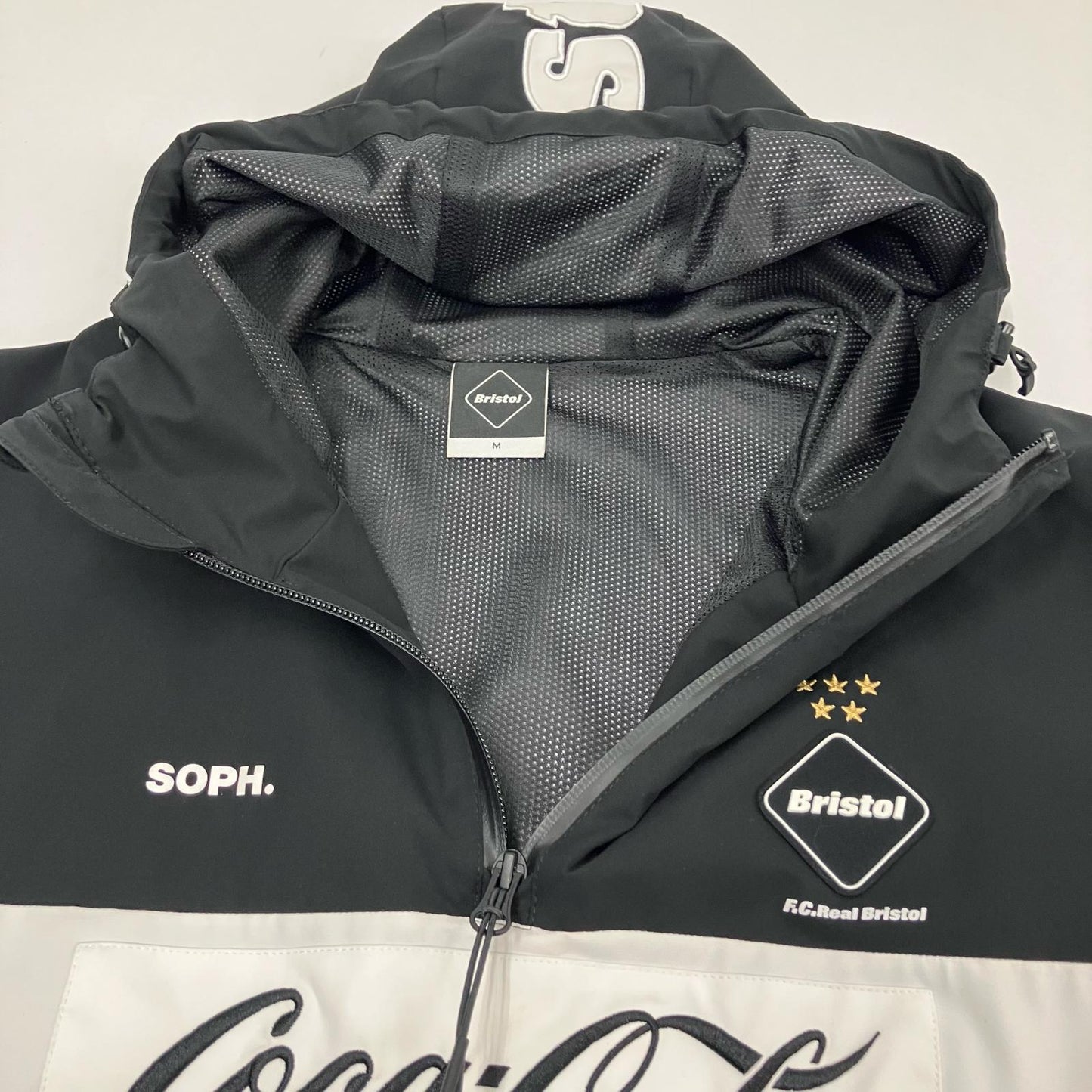 FCRB | エフシーアールビー COCA-COLA HALF ZIP ANORAK その他アウター FCRB-200002 ブラック サイズ：M【イオン広店】
