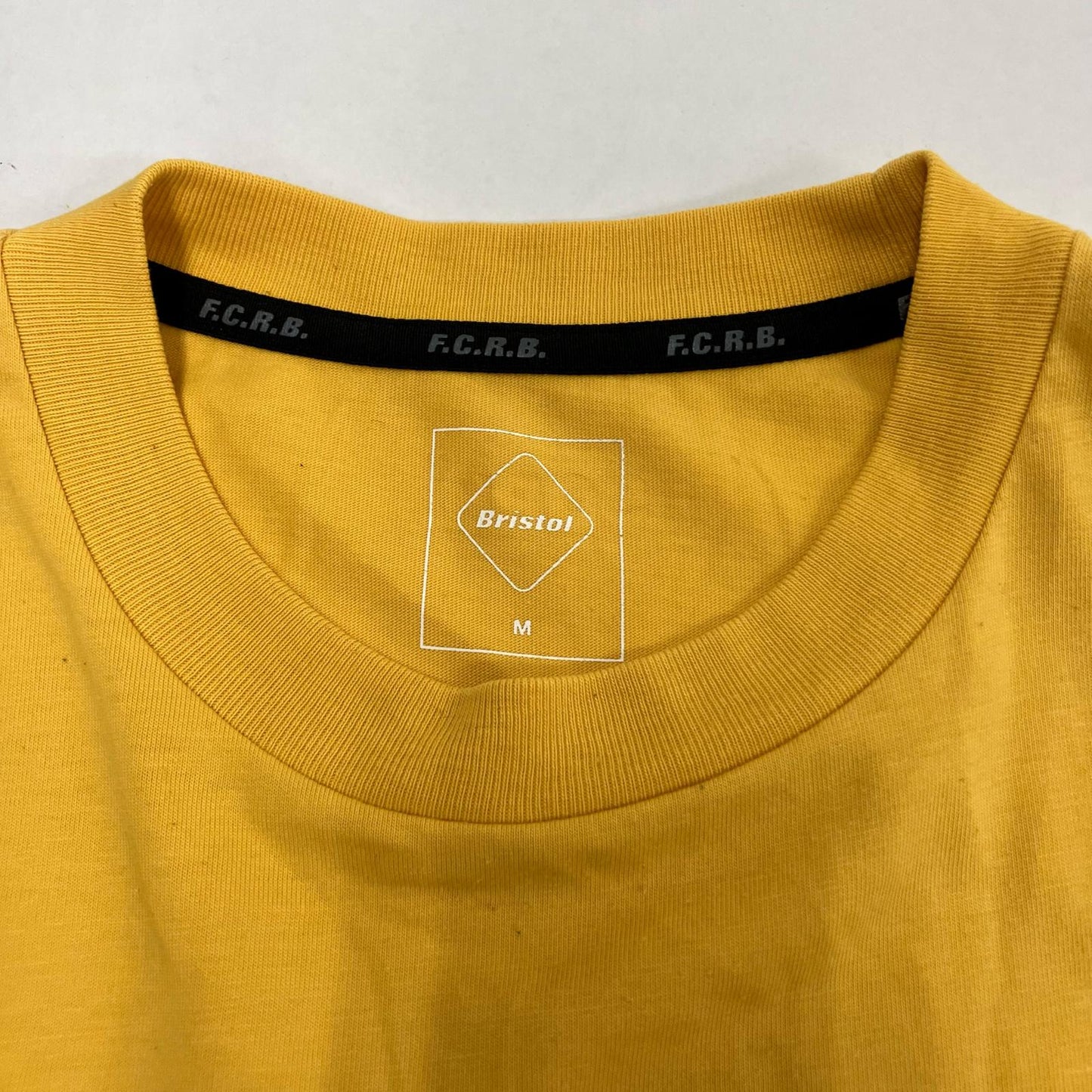 FCRB | エフシーアールビー L/S AUTHENTIC TEAM POCKET TEE 長袖Ｔシャツ FCRB-222073 イエロー サイズ：M【イオン広店】