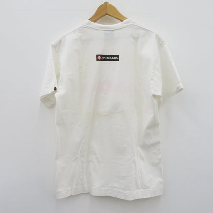 A BATHING APE | アベイシングエイプ ｹﾞｰﾑﾀｸﾞ NIGOﾛｺﾞ 半袖Ｔシャツ ホワイト サイズ：L【瀬戸大橋店】